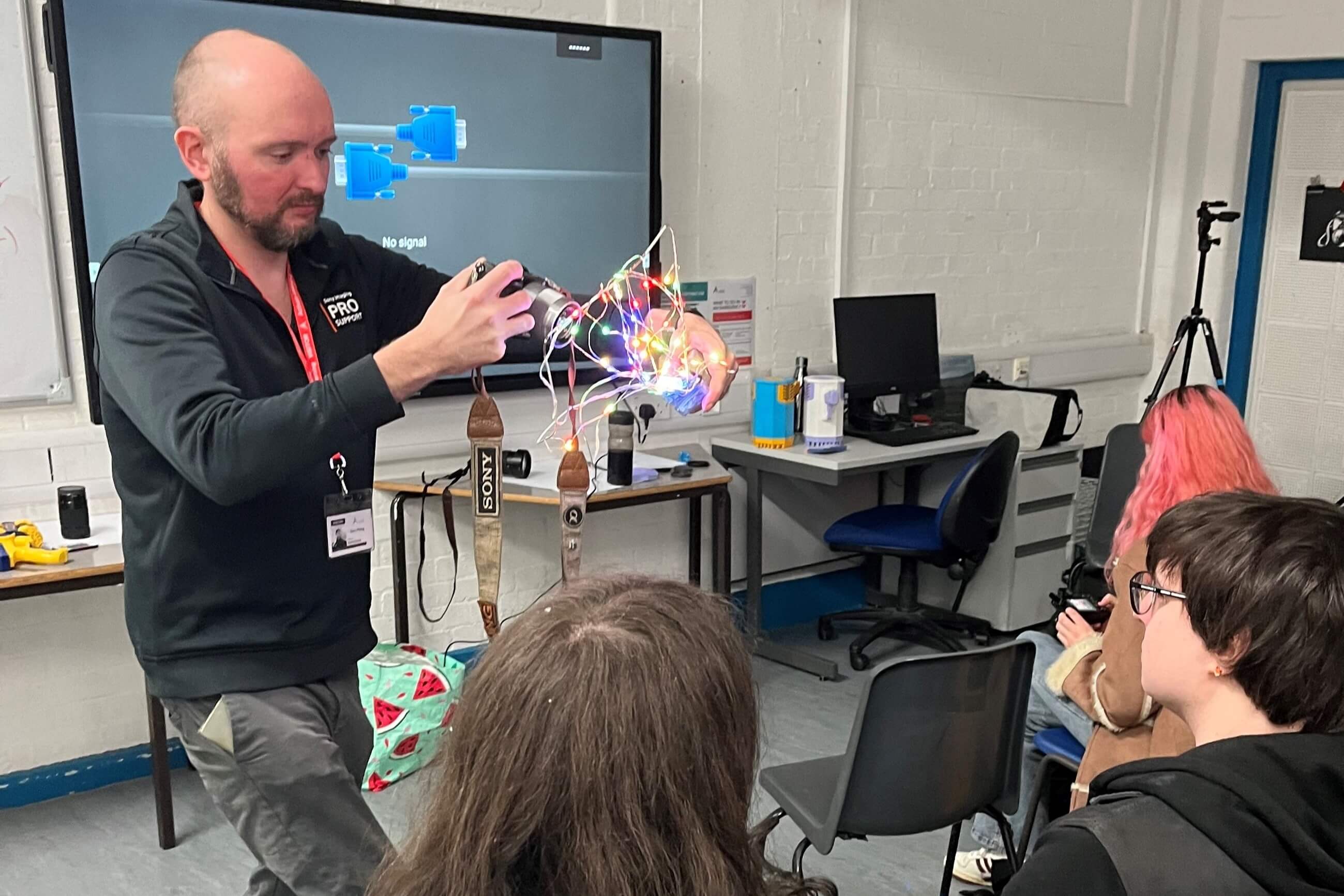 Group photo showing three Sony employees chatting over coffee